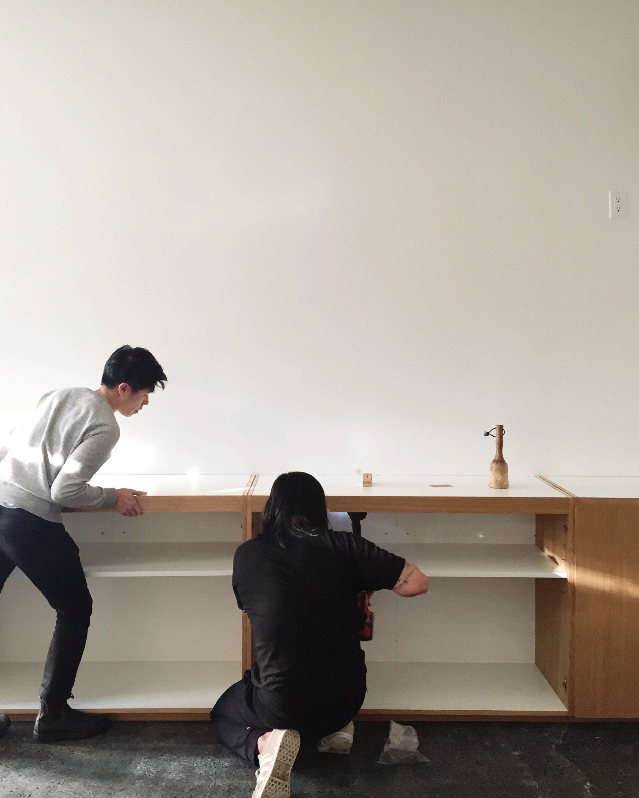 Installing the original wood cabinets at SORT in Vancouver