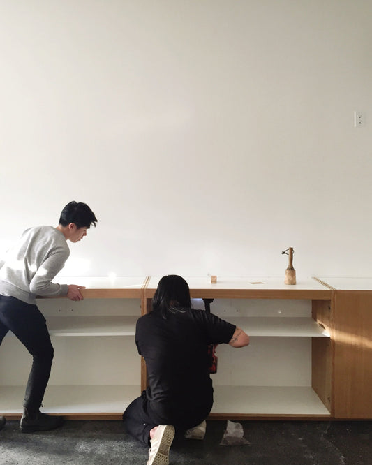 Installing the original wood cabinets at SORT in Vancouver